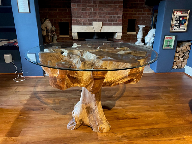 Product photograph of Naga Reclaimed Teak Root Dining Table from The Garden Furniture Centre Ltd