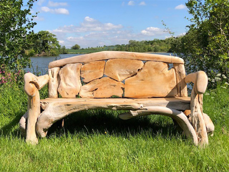 Product photograph of Naga Reclaimed Teak Root Bench from The Garden Furniture Centre Ltd